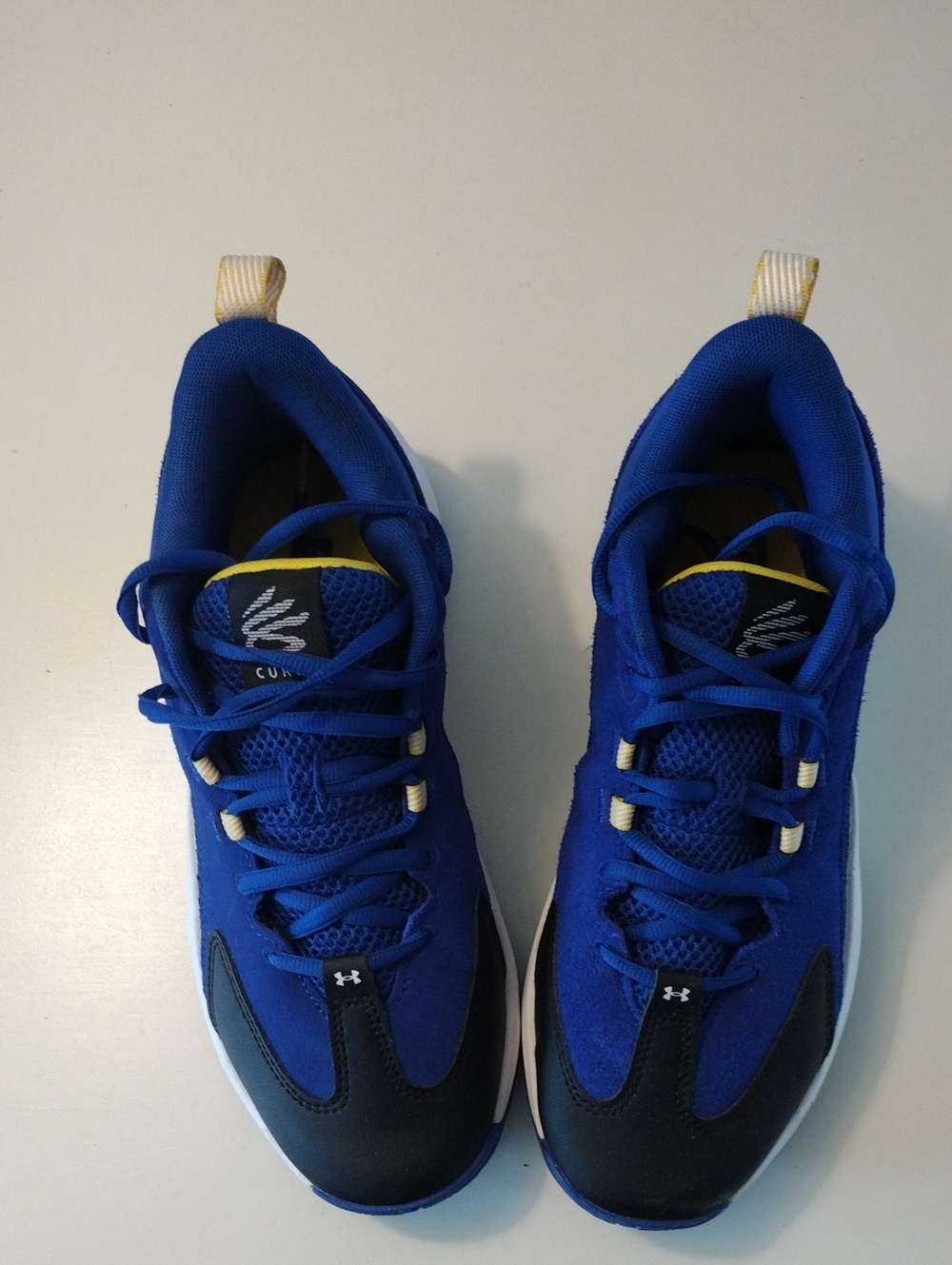 Under Armour Curry 3Z 25 Blue and Black Athletic Sneakers with Yellow Accents.